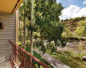 Bright hotel guestroom with window and king size bed at the DoubleTree by Hilton Durango.