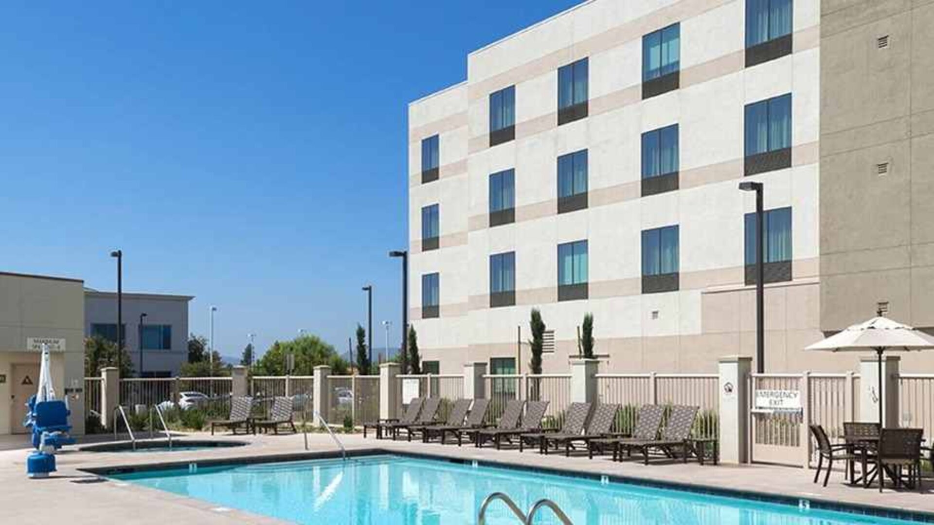 Beautiful outdoor pool with seating area and sun beds at Hampton Inn & Suites Murrieta Temecula.