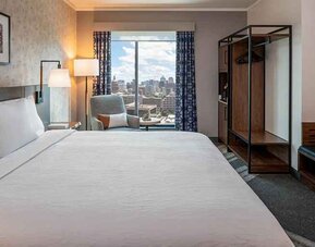 Spacious king suite with business desk and city views at Hilton Garden Inn Austin University.