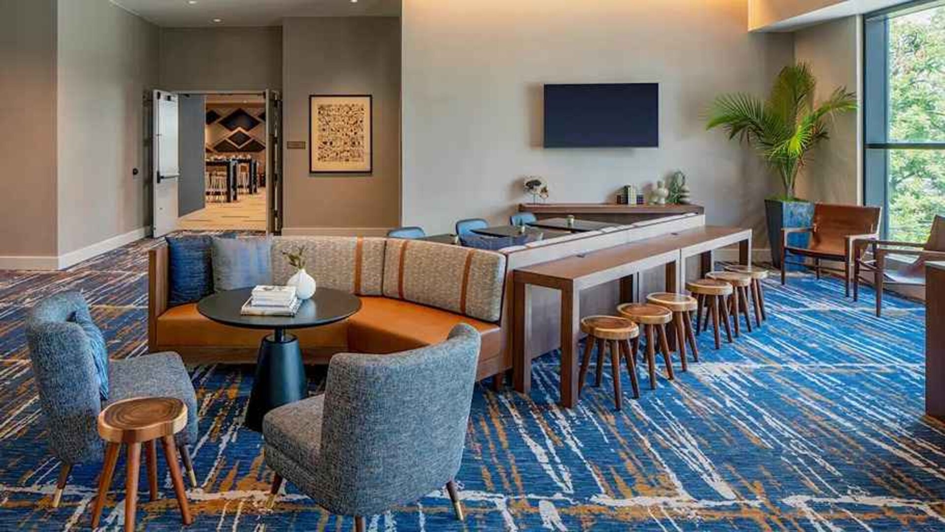 A coworking space with lots of natural light at Hilton Garden Inn Austin University.