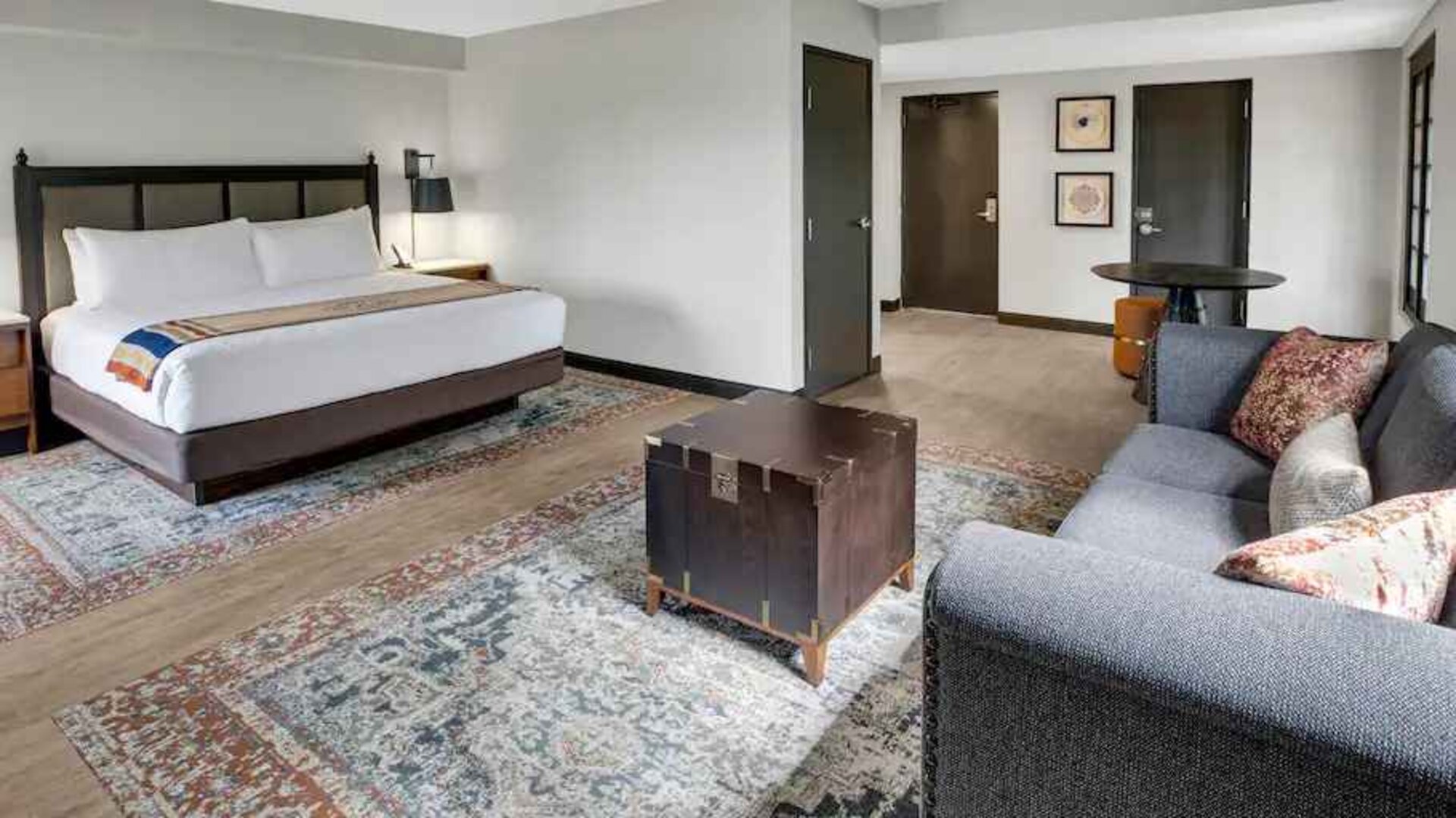 Large guestroom with king size bed and working station at the Estancia del Norte San Antonio, Tapestry Collection.