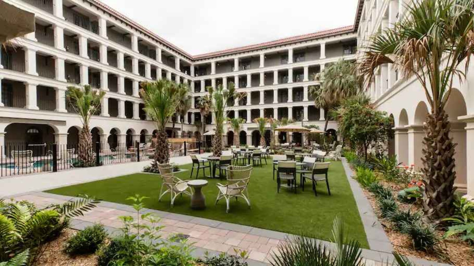 Outdoor workspace with tables and chairs at the Estancia del Norte San Antonio, Tapestry Collection.