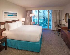 spacious king room with TV and business desk at DoubleTree Resort by Hilton Hollywood Beach.