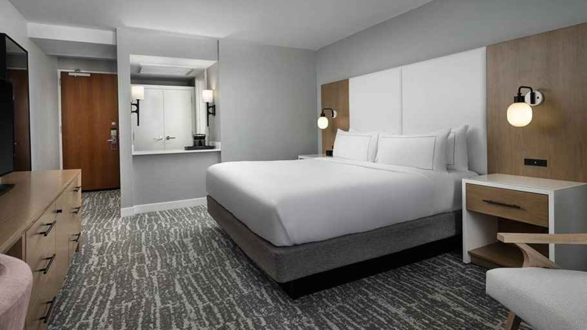 comfortable king bedroom with work desk at Hilton Myrtle Beach Resort.