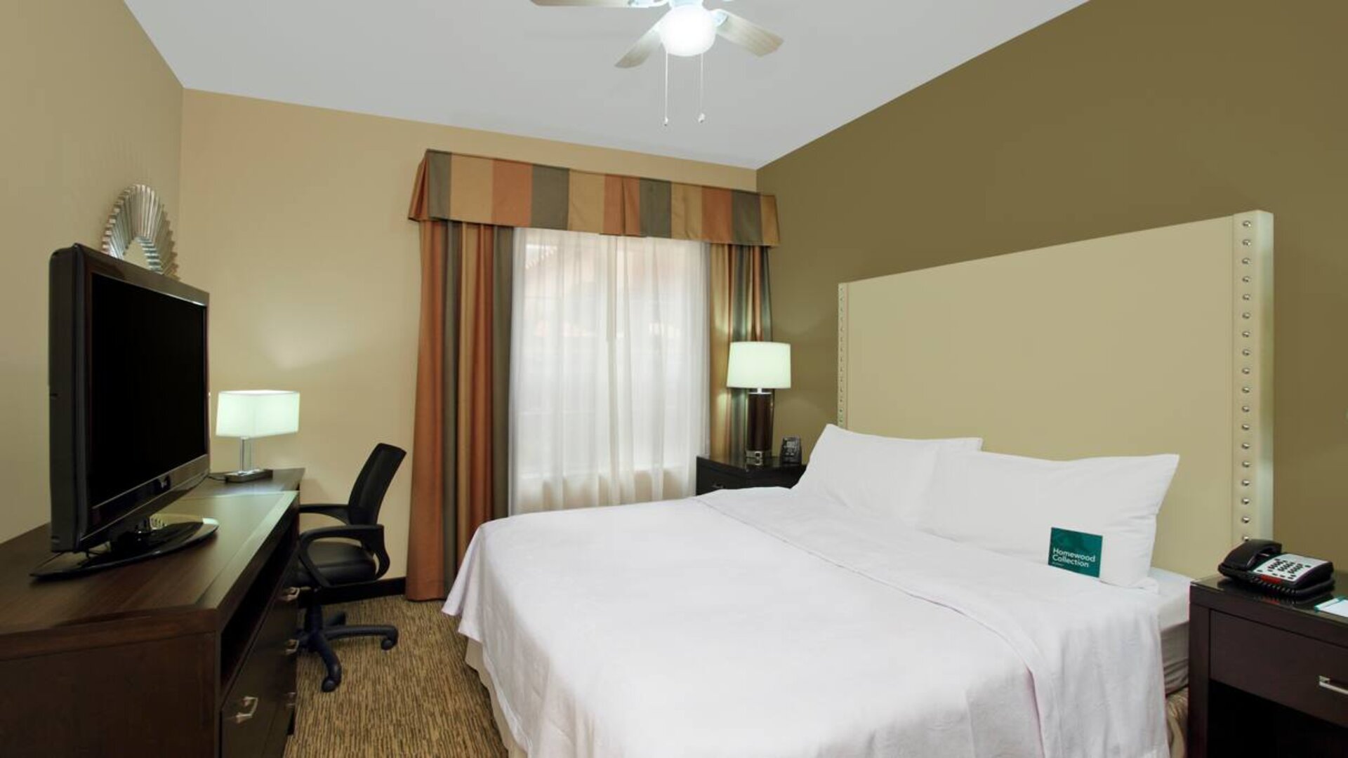 comfortable king delux room full furnished with TV and work desk at Homewood Suites by Hilton Houston-Woodlands.