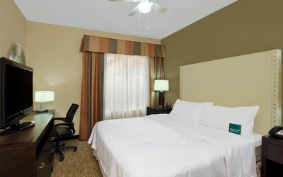 comfortable king delux room full furnished with TV and work desk at Homewood Suites by Hilton Houston-Woodlands.