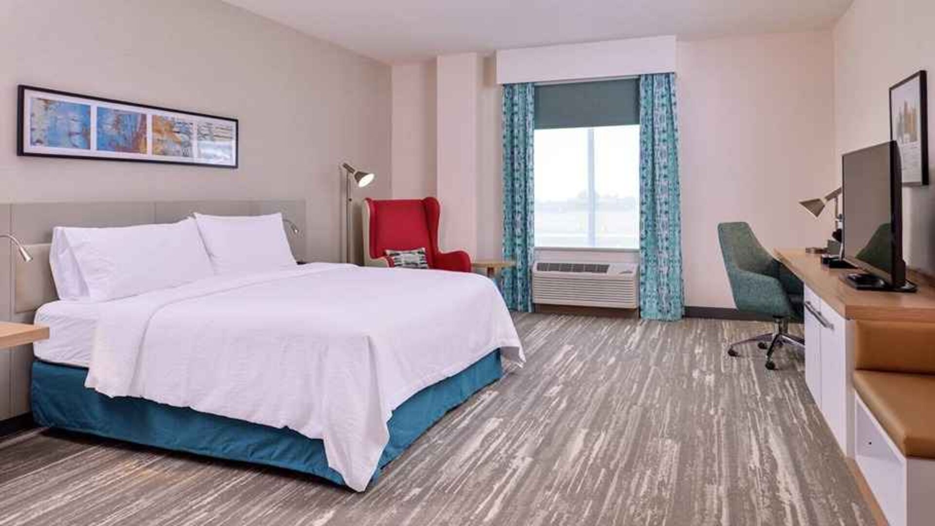 spacious king room with work desk, TV, and natural light aat Hilton Garden Inn Kansas City Airport.