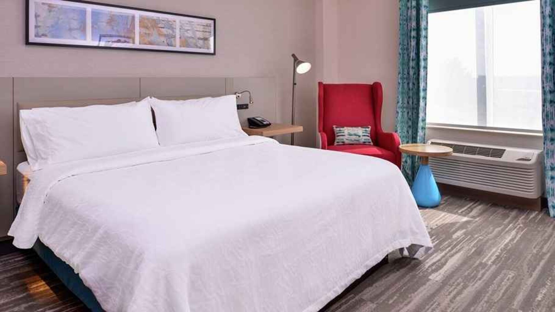 comfortable delux king room with natural light at Hilton Garden Inn Kansas City Airport.