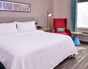 comfortable delux king room with natural light at Hilton Garden Inn Kansas City Airport.