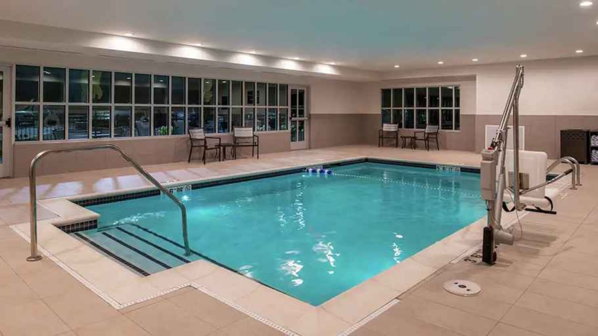 indoor pool with seating and accessible to otherwise-abled guests at Hilton Garden Inn Kansas City Airport.