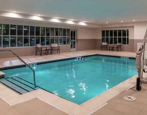 indoor pool with seating and accessible to otherwise-abled guests at Hilton Garden Inn Kansas City Airport.