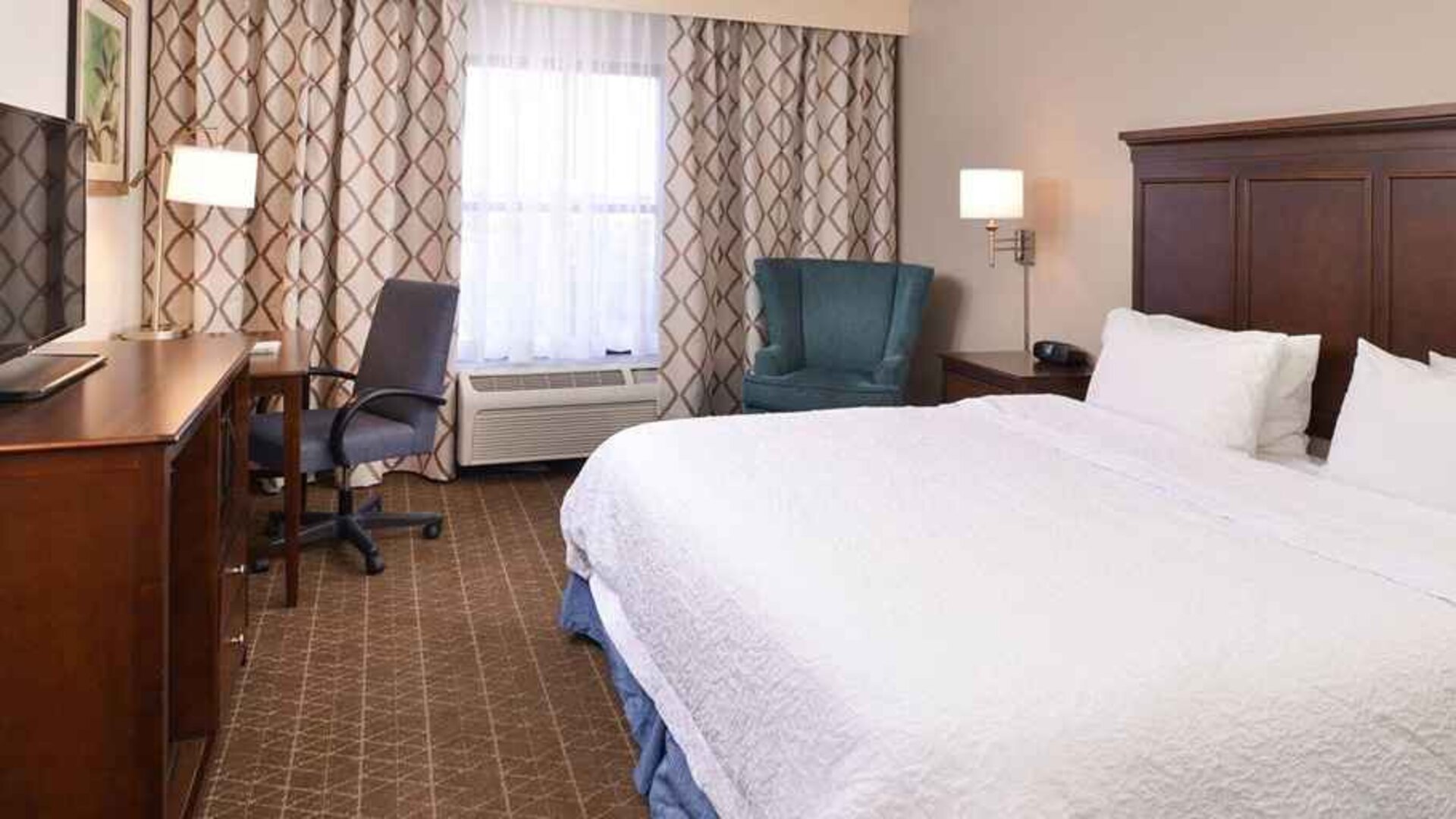 Delux king room with TV and work desk at Hampton Inn & Suites Pueblo-Southgate.