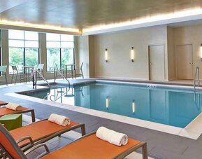 Relaxing indoor pool with comfortable seating at Hilton Garden Inn Boston/Marlborough.
