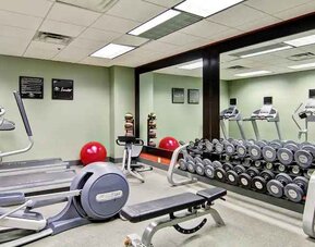 Fitness center with mirrors at the Homewood Suites by Hilton Washington, D.C. Downtown.