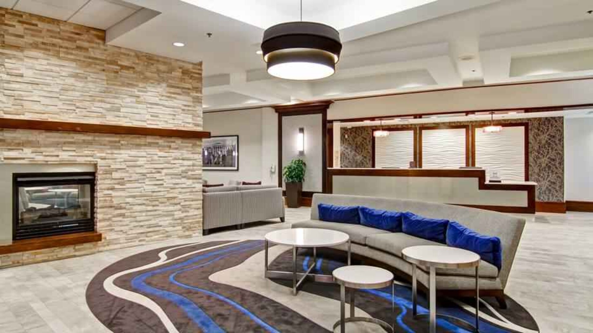 Workplace by the fireplace in a hotel lobby at the Homewood Suites by Hilton Washington, D.C. Downtown.