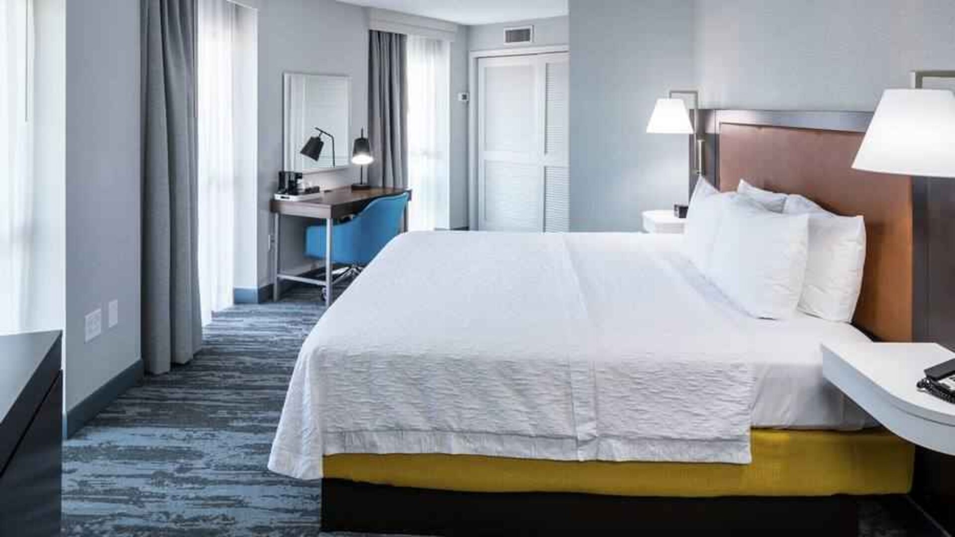 Bright king bedroom with big window at the Hampton Inn & Suites Memphis-Beale Street.