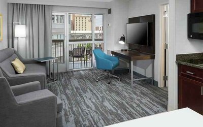 Living room with working station in a hotel suite at the Hampton Inn & Suites Memphis-Beale Street.