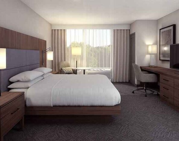 Spacious king bedroom with king size bed and sofa at the DoubleTree by Hilton Lafayette East.