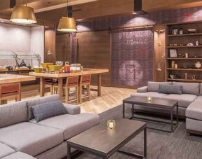 Dining area with tables and chairs at the DoubleTree by Hilton Lafayette East.