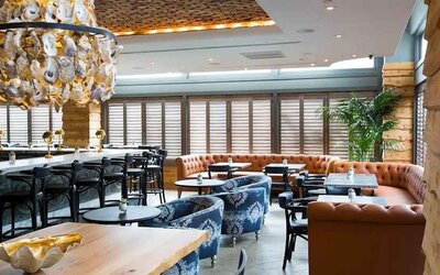 Comfortable lobby and restaurant area ideal as a coworking space at The Sam Houston, Curio Collection by Hilton.