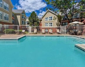 beautiful outdoor pool with sun beds and seating area at Homewood Suites by Hilton - Boulder.