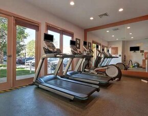 well-equipped fitness center with lots of natural light at Homewood Suites by Hilton - Boulder.