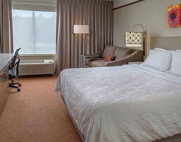 comfortable king delux room with TV and work desk ideal for working remotely at Hilton Garden Inn St. Louis/Chesterfield.