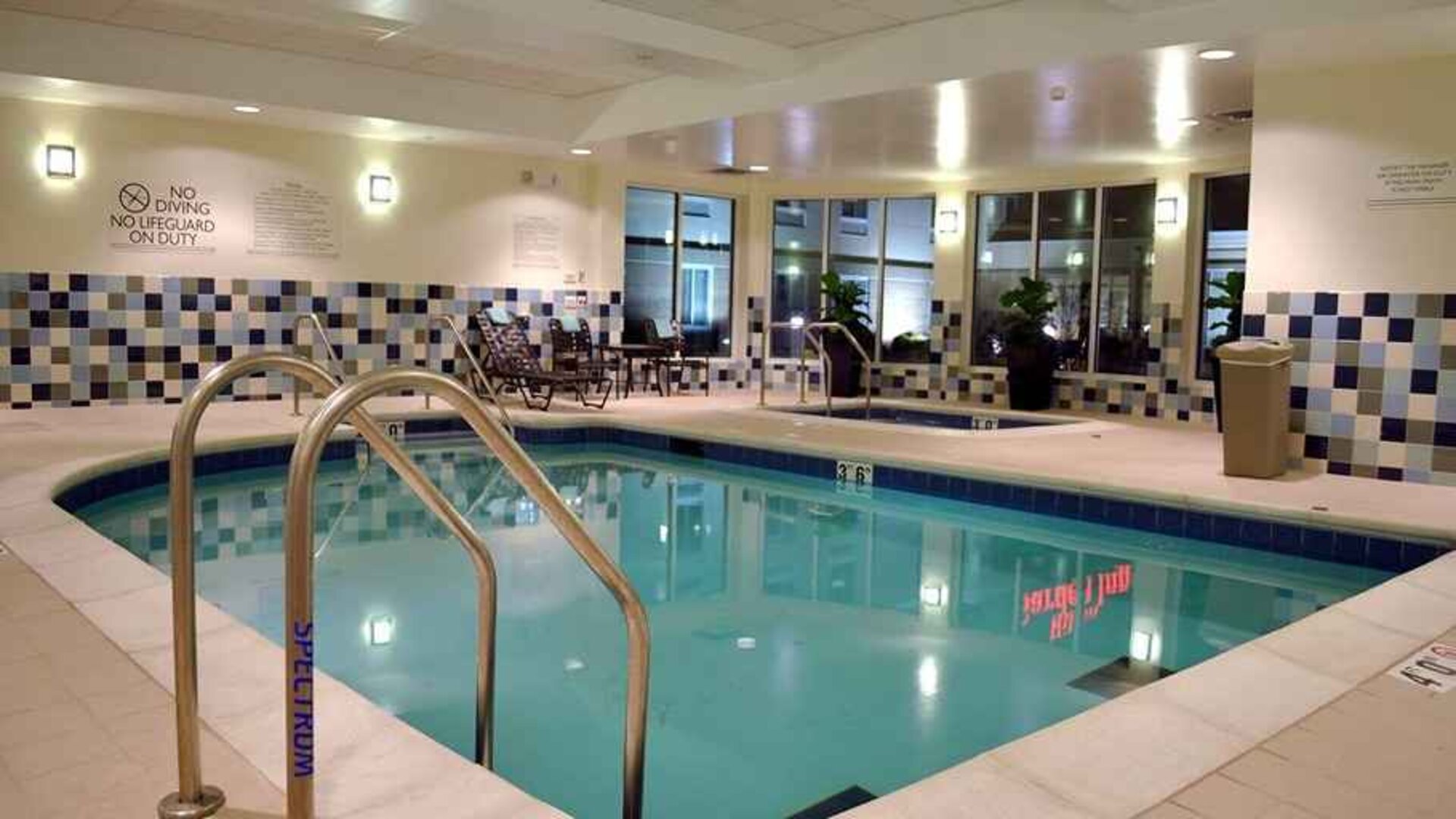 relaxing indoor pool with comfortable seating at Hilton Garden Inn St. Louis Airport.