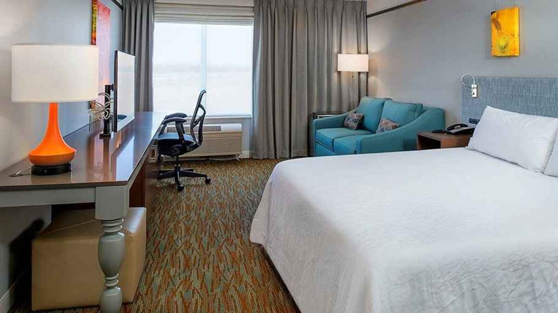 spacious delux king room with lounge area and work desk ideal for working remotely at Hilton Garden Inn St. Louis/O'Fallon MO.