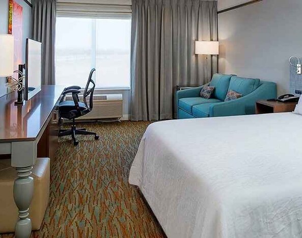 spacious delux king room with lounge area and work desk ideal for working remotely at Hilton Garden Inn St. Louis/O'Fallon MO.