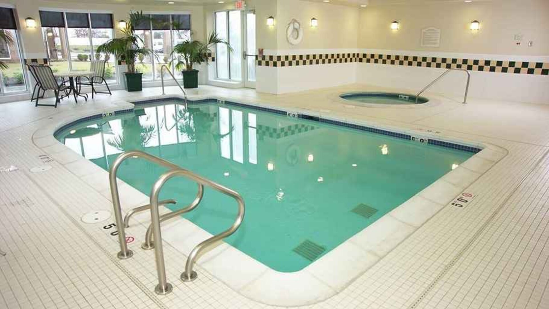 relaxing indoor pool with surrounding seating area at Hilton Garden Inn St. Louis/O'Fallon MO.