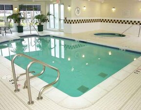 relaxing indoor pool with surrounding seating area at Hilton Garden Inn St. Louis/O'Fallon MO.
