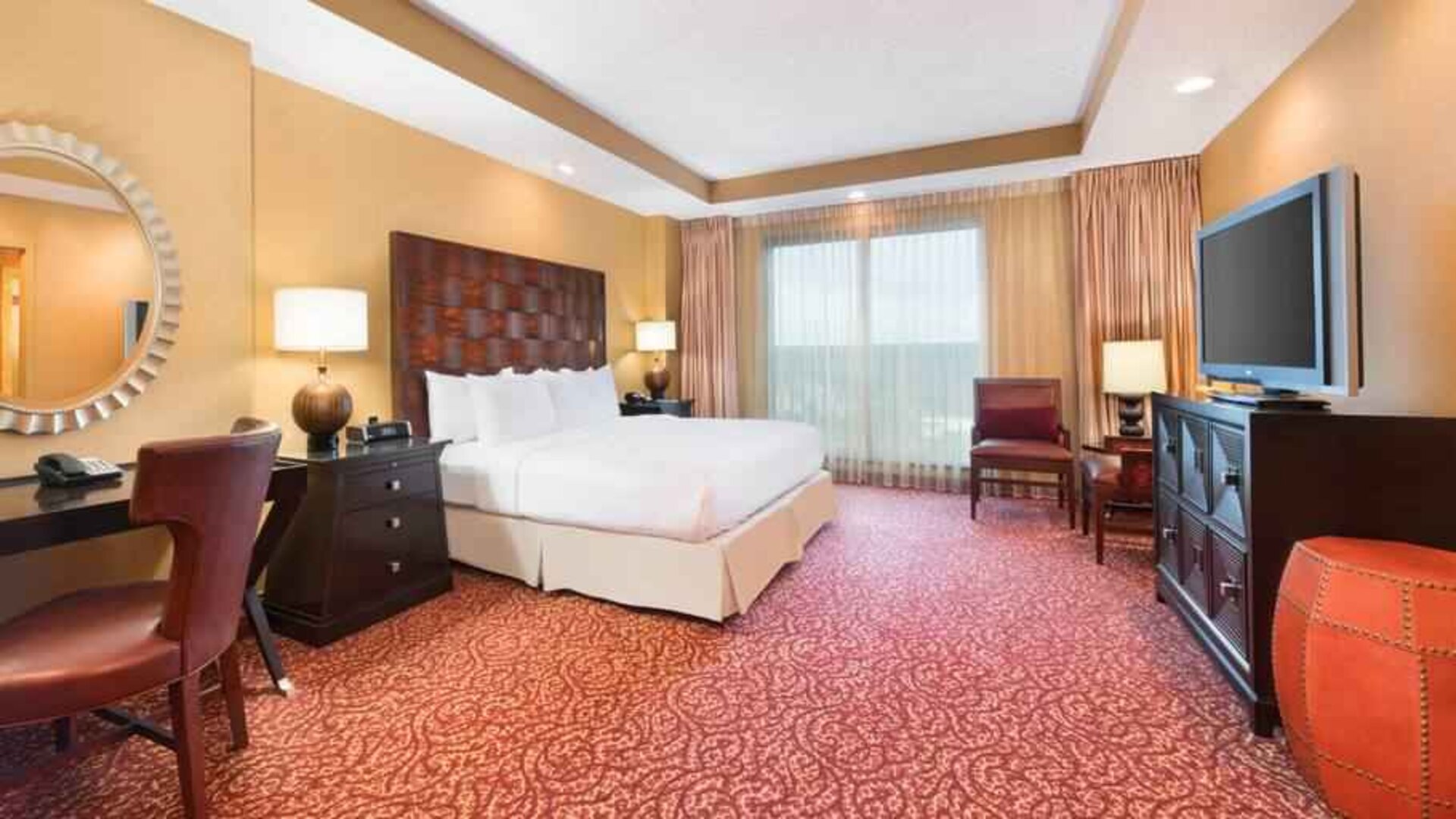 Spacious presidential suite with window, desk and TV screen at the Embassy Suites by Hilton Nashville SE Murfreesboro.