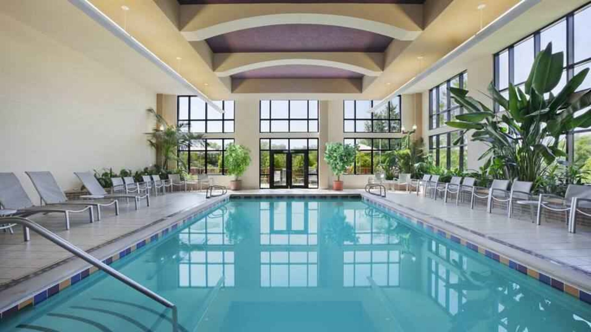 Bright hotel area with indoor pool at the Embassy Suites by Hilton Hot Springs Hotel & Spa.