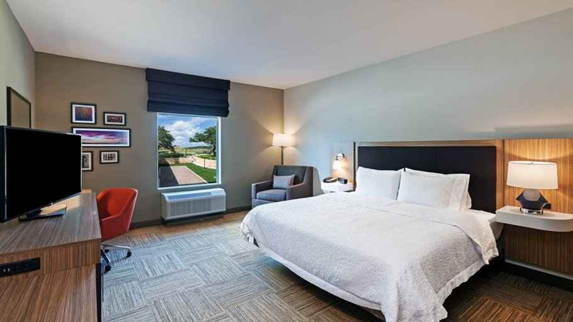 spacious king bedroom with work desk and natural light ideal for working remotely at Hampton Inn Bulverde Texas Hill Country.