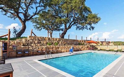 beautiful outdoor pool with comfortable seating area at Hampton Inn Bulverde Texas Hill Country.