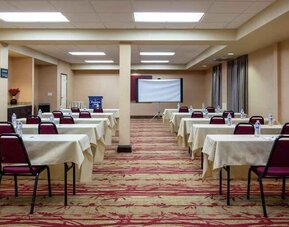 Large meeting room with tables and chairs at the Hampton Inn Albuquerque, University-Midtown (UNM).