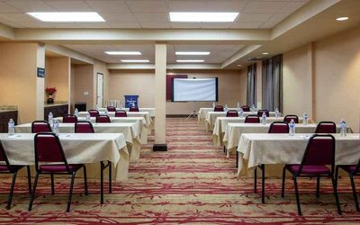 Large meeting room with tables and chairs at the Hampton Inn Albuquerque, University-Midtown (UNM).