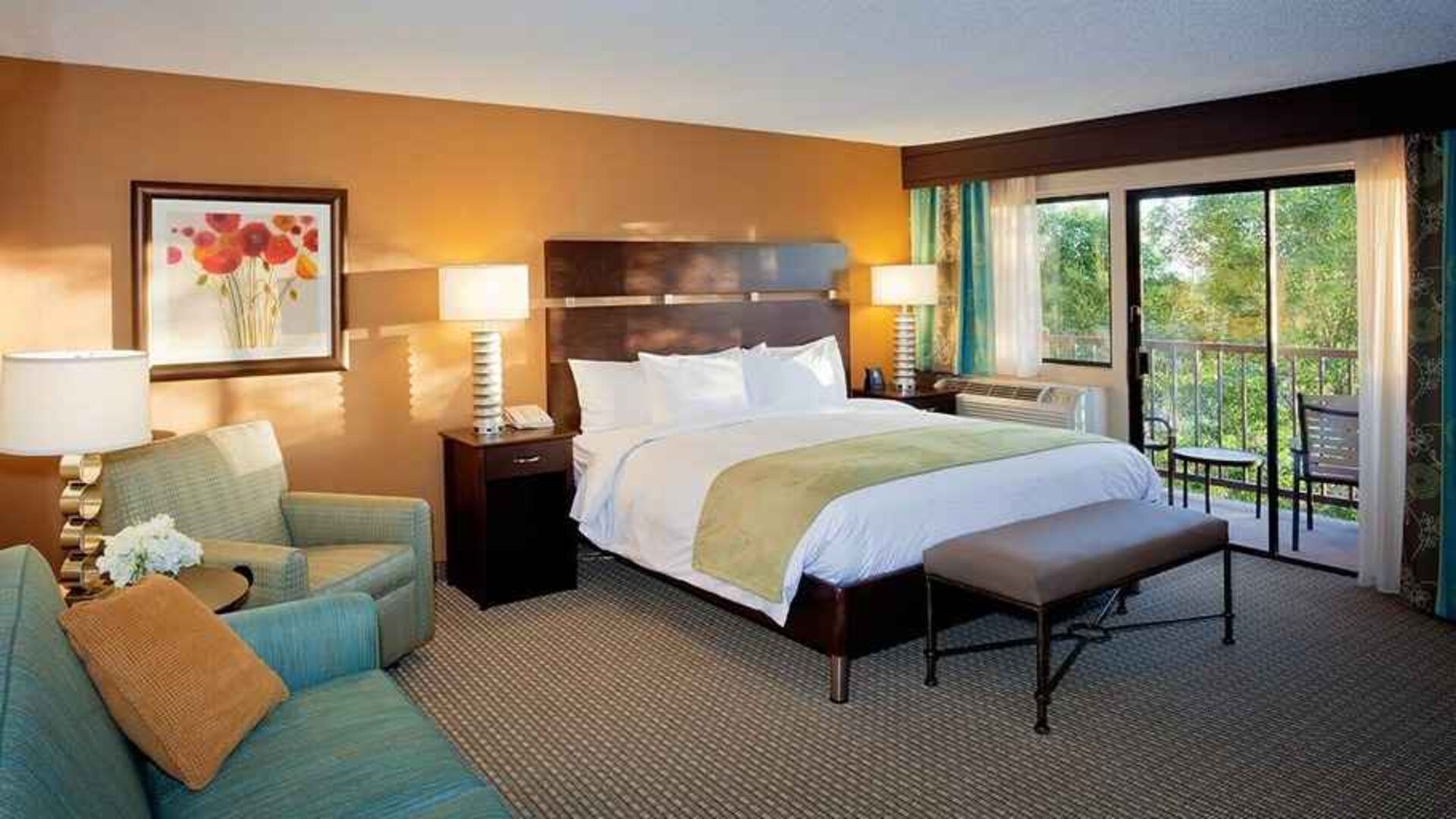 spacious king suite with balcony seating and lounge area at DoubleTree by Hilton Hotel Santa Fe.