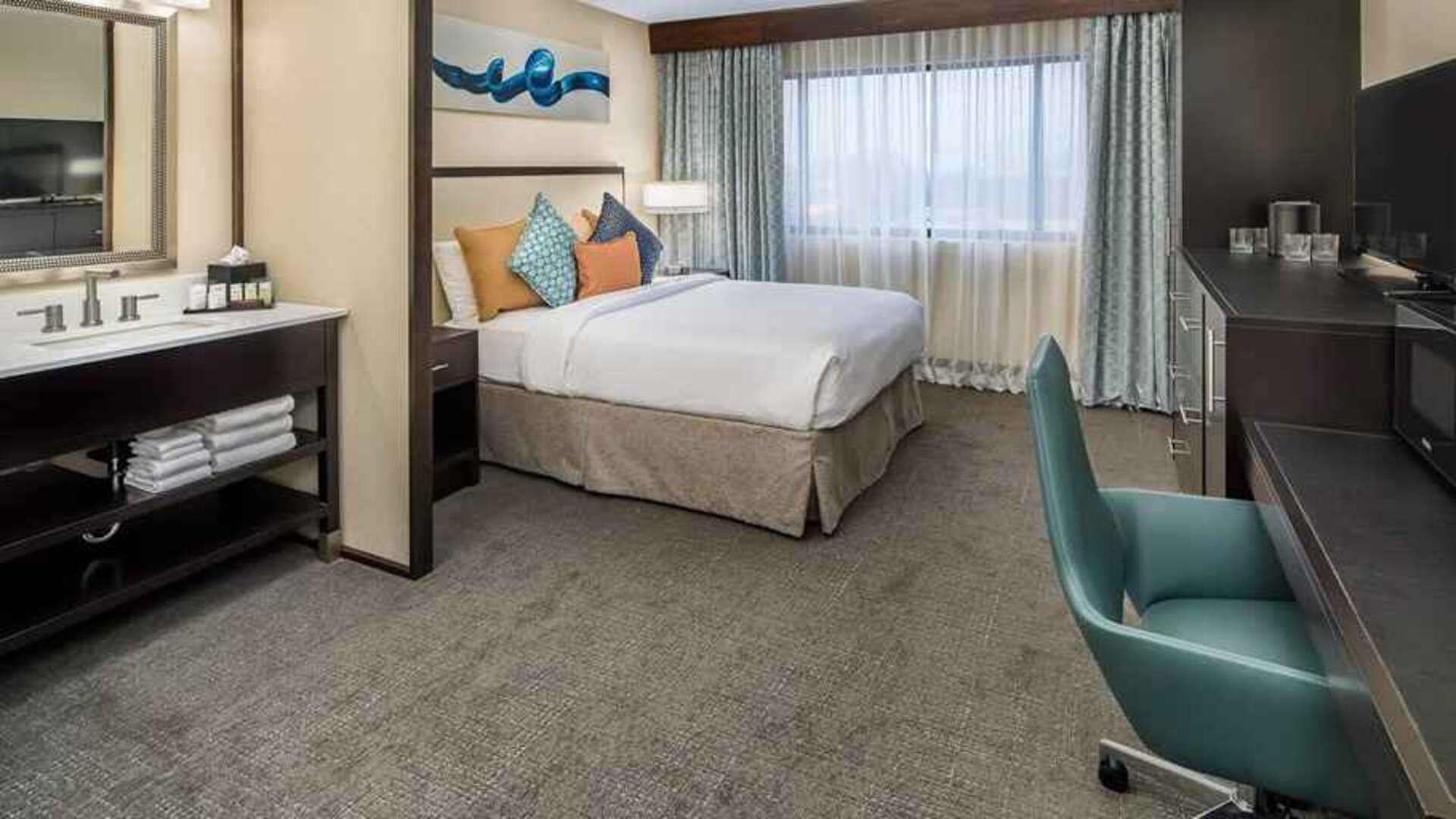 Spacious king room with work desk ideal for working remotely at Embassy Suites by Hilton Seattle Tacoma International Airport.