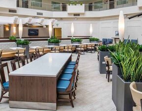 Comfortable lobby lounge area ideal as a coworking space at Embassy Suites by Hilton Seattle Tacoma International Airport.