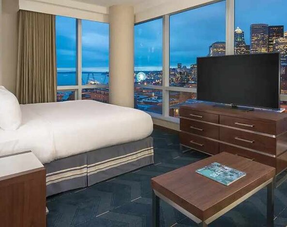 beautiful king suite with TV and city views at Embassy Suites by Hilton Seattle Downtown Pioneer Square.