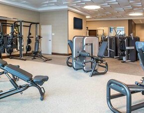 fully equipped fitness center with weights and exercise equipment at Embassy Suites by Hilton Seattle Downtown Pioneer Square.