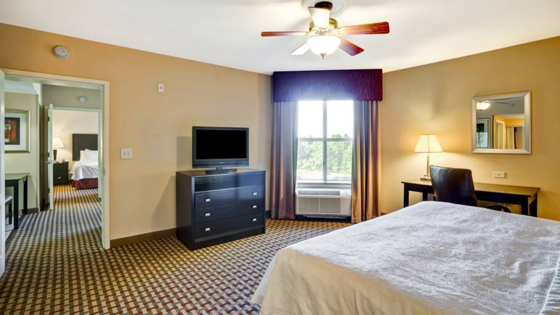 KIng bedroom with window and desk at the Homewood Suites by Hilton Bel Air.