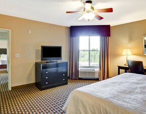 KIng bedroom with window and desk at the Homewood Suites by Hilton Bel Air.