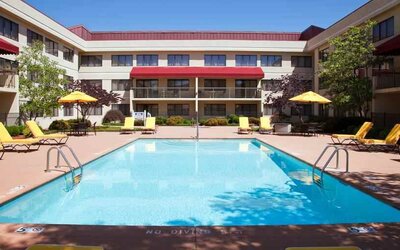 Outdoor pool area with lounges at the DoubleTree Suites by Hilton Cincinnati-Blue Ash.