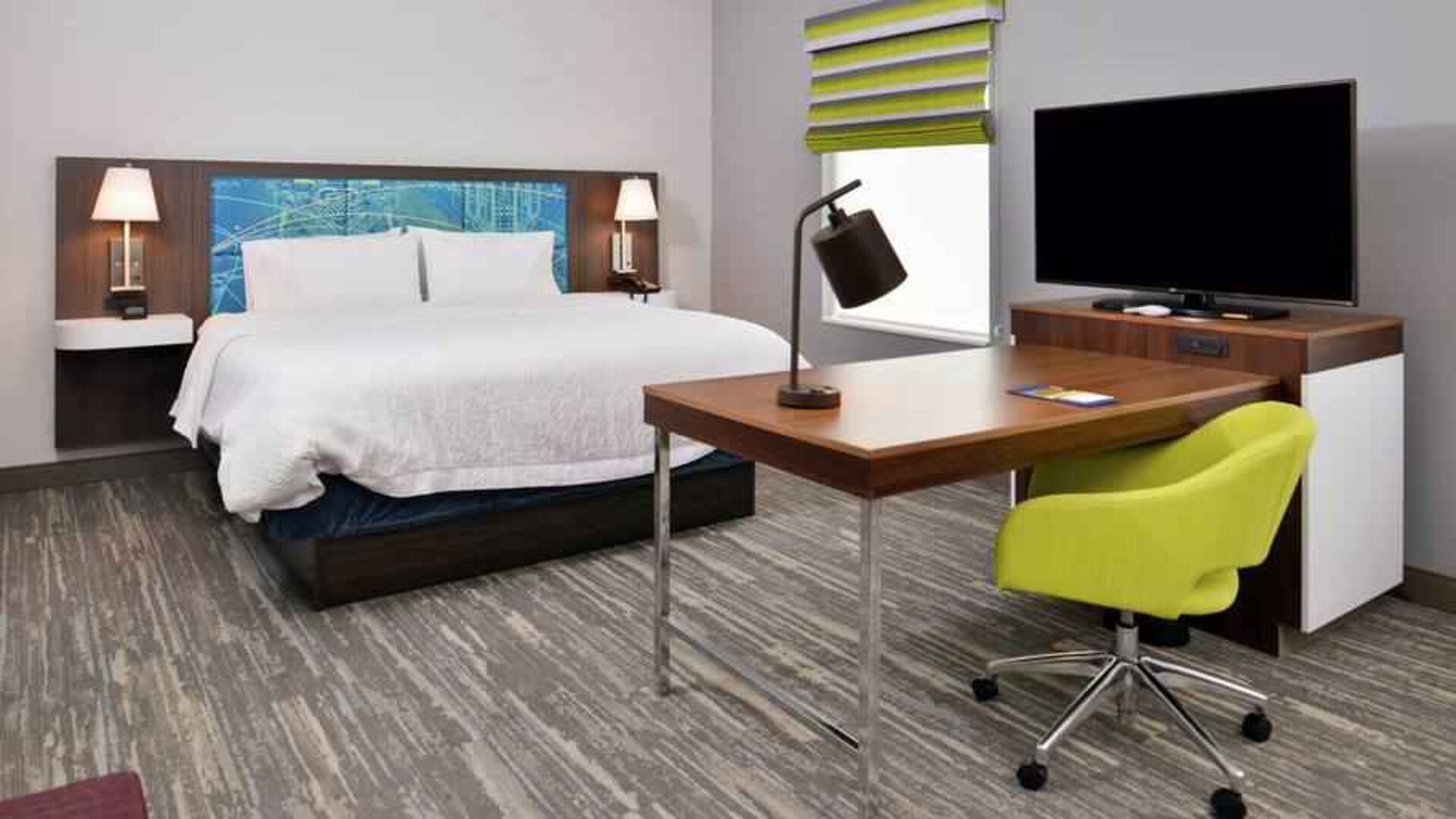 Working station in a hotel room with king size bed at the Hampton Inn & Suites St. Paul Oakdale/Woodbury by Hilton.