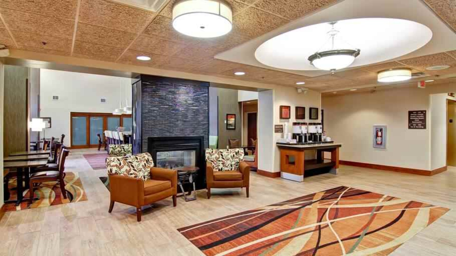 Comfortable lobby workspace by the fireplace at the Hampton Inn & Suites Leesburg.