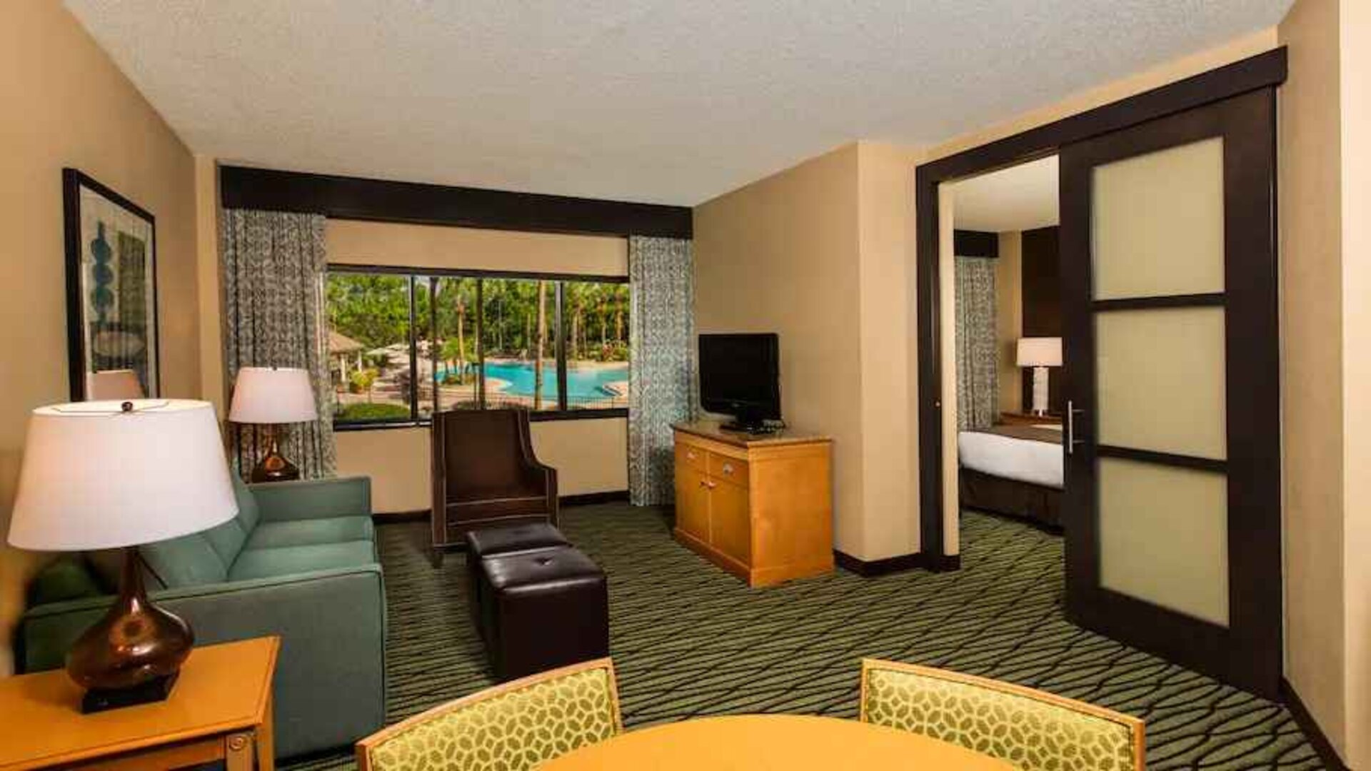 Spacious living room with working station at the DoubleTree Suites by Hilton Orlando - Disney Springs Area.