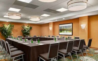 Meeting room with square conference table at the DoubleTree Suites by Hilton Orlando - Disney Springs Area.